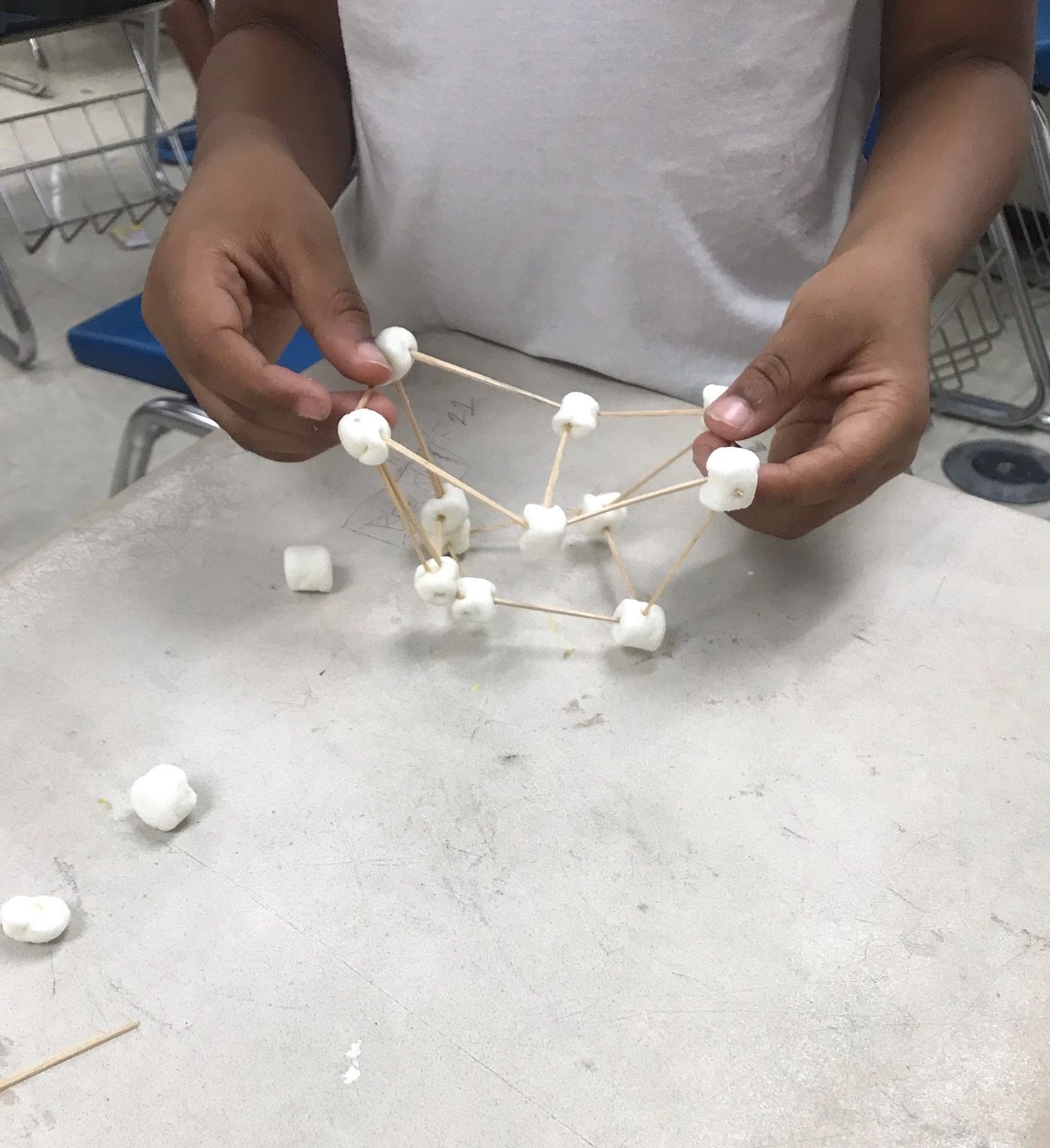 Student building marshmallow and toothpick structure at Morgan State University summer camp