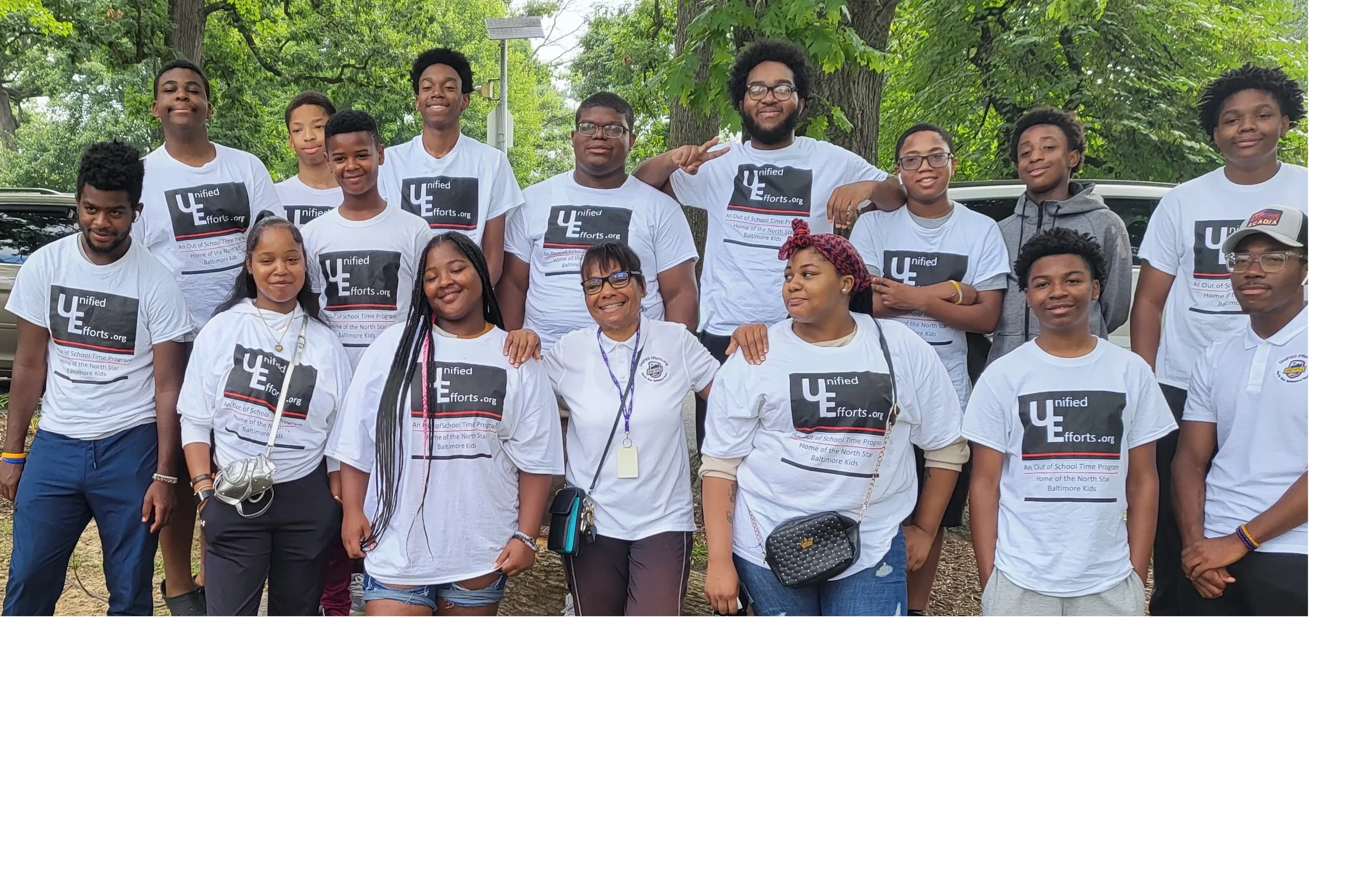 Unified Efforts group in white shirts at community event